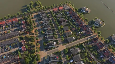 Aerial view flying over dutch residential neighborhood near a lake Stockbeeldmateriaal 342812089