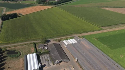 Aerial view flying over dutch farms towards moerdijk port Stock Footage 342813681