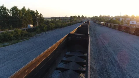 Aerial view. Flying over empty railroad cars for rubble on the rails at sunset. Stock-Footage 94496862