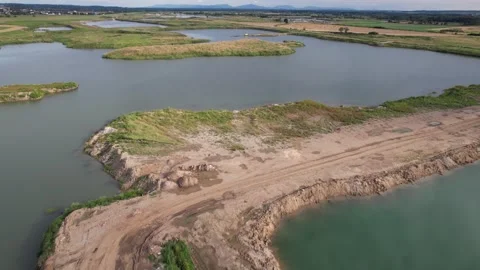 Aerial view flying over a flooded sand quarry and beautiful green lake landscape Vidéo 347864530