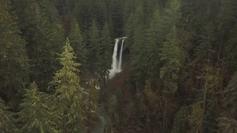 Aerial view flying over forest towards large waterfall Video stock 75964575