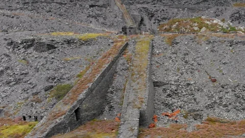 Aerial view flying over the forest with the abandoned mine in North Wales Stock Footage 119621806