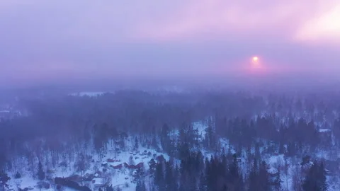 Aerial view flying over forest in sunset snowstorm winter landscape Stock Footage 252306730