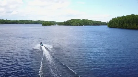 Aerial View Flying Over Fresh Water Lake Following Jetski 1 Stock Footage 77317880
