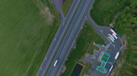 Aerial View. Flying over the green sown field along the road with cars. Stock Footage 63782883