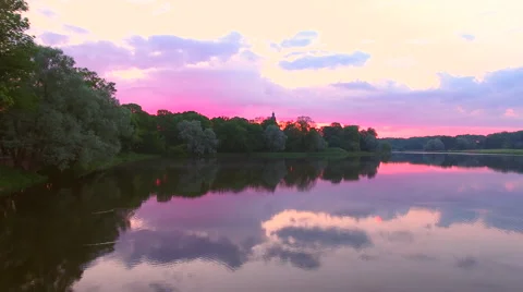Aerial View. Flying over the green trees above the river at dawn with Stock Footage 63821573