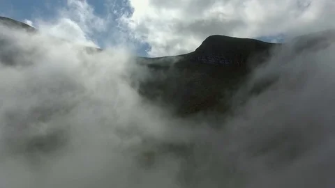 Aerial View. Flying over the high mountains in beautiful clouds. Stock Footage 81221207