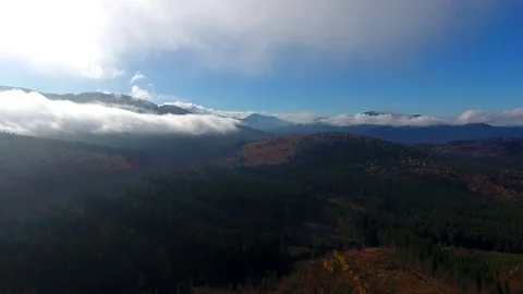 Aerial View. Flying over the high autumn mountains in beautiful clouds . Aerial Stock Footage 83129019