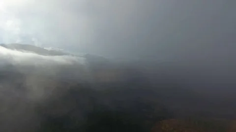 Aerial View. Flying over the high autumn mountains in beautiful clouds . Aerial Stock Footage 83129078