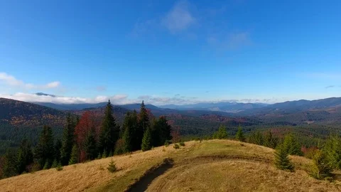 Aerial View. Flying over the high autumn mountains in beautiful clouds . Aerial Stock Footage 83129220