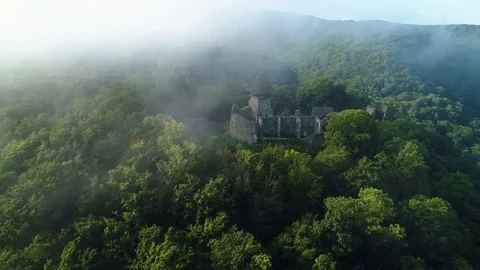 Aerial View. Flying over the high mountains and ancien Castle in beautiful Stock Footage 83550900