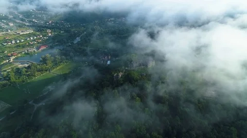 Aerial View. Flying over the high mountains in beautiful clouds . Aerial camera Stock Footage 83551187