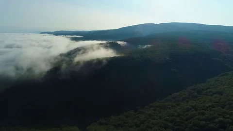 Aerial View. Flying over the high mountains in beautiful clouds . Aerial camera 库存影片 83551295