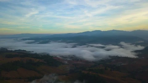 Aerial View. Flying over the high mountains in beautiful clouds morning. Video stock 87189434