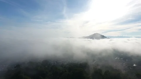Aerial View. Flying over the high mountains in beautiful clouds Видео 89716518