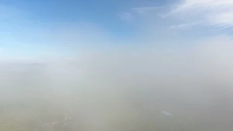 Aerial View. Flying over the high mountains in beautiful clouds . Видео 89719926
