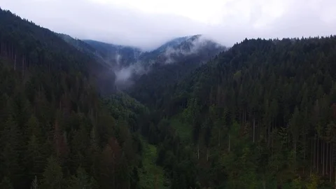 Aerial View. Flying over the high mountains in beautiful clouds . Aerial camera Stock Footage 98130985