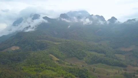 	 Aerial View. Flying over the high mountains forest with beautiful clouds fog,  Stock Footage 163653201
