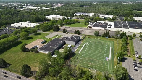 Aerial view flying over high school american football field Stock Footage 337422056