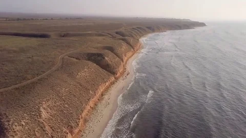 Aerial view, flying over the hilly coast of the Black sea and rise up Video stock 84177426