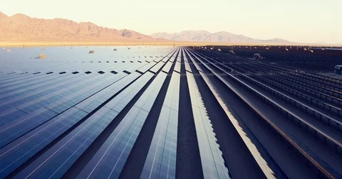 Aerial view flying over large solar farm in desert, clean renewable energy Stock Footage