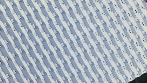 Aerial view flying over large dutch greenhouses and solar panels in Westland Stock Footage 338030776