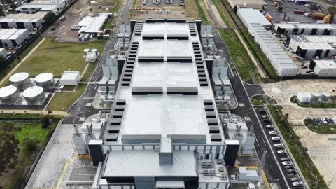 Aerial view flying over large industrial data center building Stock Footage 342328340