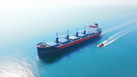 AERIAL VIEW: Flying over massive ship filled moving in the quiet sea. Cargo Stock Footage 107445435