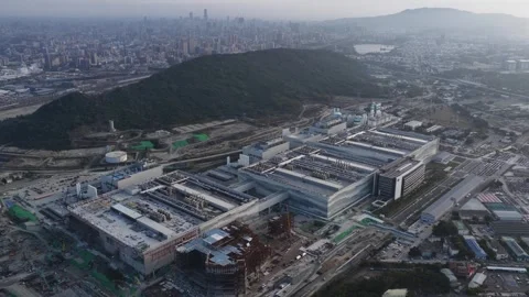 Aerial view flying over the massive tsmc fab 20 semiconductor fabrication plant Stock Footage 332035600