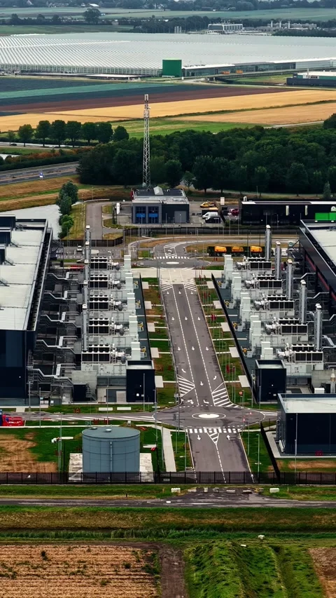 Aerial view flying over the massive Microsoft hyperscale data center in Stock Footage 346576122
