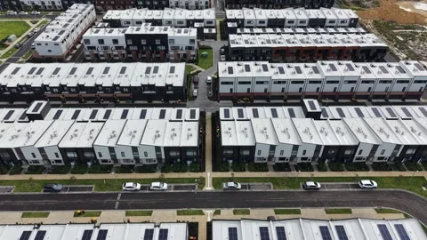 Aerial view flying over modern townhouses with solar panels Video stock 342327295