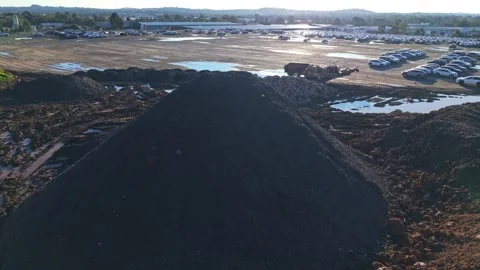 Aerial view flying over mound of soil in a construction site Stock Footage 340133069