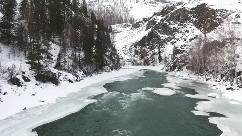 Aerial view . Flying over a mountain river in the winter. Stock Footage 109601927