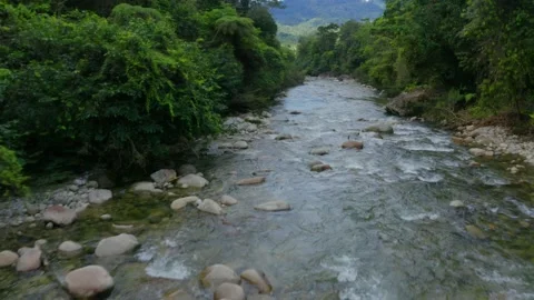 Aerial view, flying over a mountain river with clear ice cold blue water Stock Footage 160323974