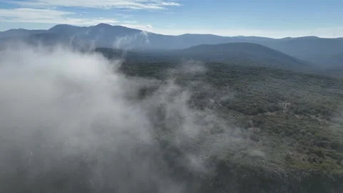 Aerial view flying over mountain peaks in clouds near Poulithra Greece with mist Video stock 302069941