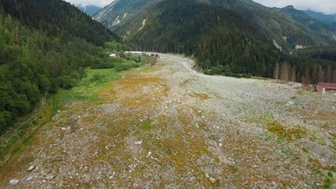 Aerial view flying over mountain valley with landslide aftermath Vidéo 344655305