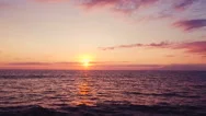 Aerial View Flying Over Ocean Into Dramatic Sunset Stock Footage