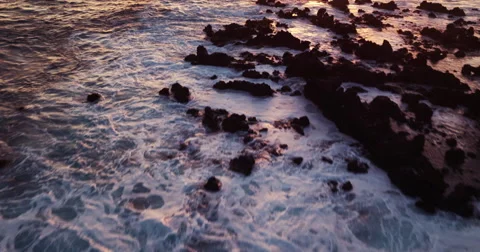 Aerial view flying over ocean into amazing sunset Stock Footage 62848027