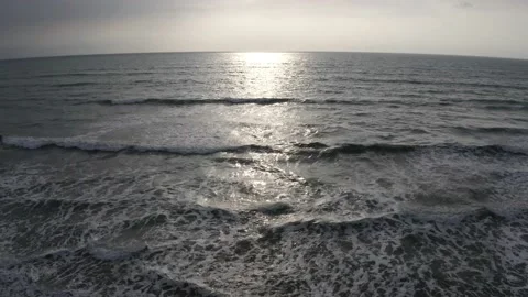 Aerial view, flying over the open ocean towards the sun at sunset Stock Footage 146754833
