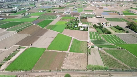 Aerial view flying over a patchwork of agricultural fields Stock Footage 339991001