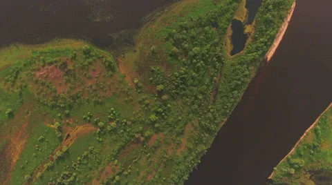 Aerial View. Flying over the river green trees at sunset with sun. Stock Footage 63823646