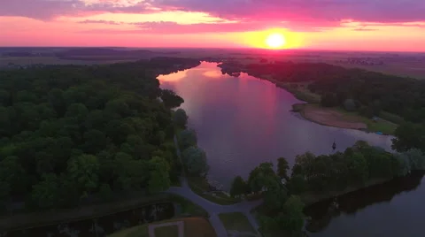 Aerial View. Flying over the river green trees at sunset with sun. Stock-Footage 63836060