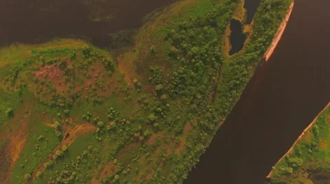 Aerial View. Flying over the river green trees at sunset with sun. Stock Footage 63840781