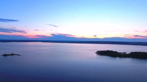 Aerial View. Flying over the river green trees at sunset with sun. Stock Footage 64035031