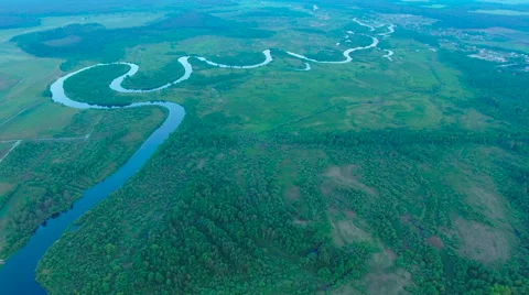 Aerial View. Flying over the river green trees at sunset with sun. Stock Footage 64960540