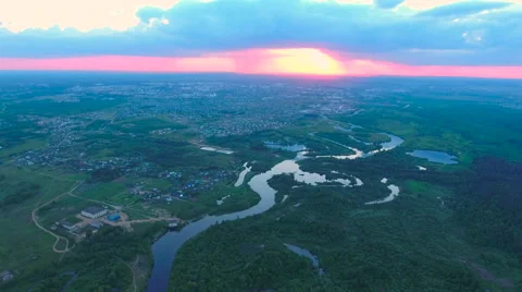 Aerial View. Flying over the river green trees at sunset with sun. Stock Footage 64960660