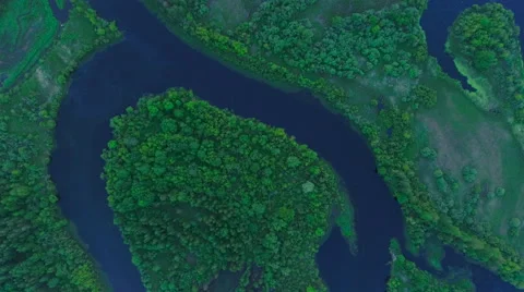 Aerial View. Flying over the river green trees at sunset with sun. Stock Footage 64960738