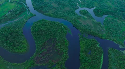 Aerial View. Flying over the river green trees at sunset with sun. Stock Footage 64961250