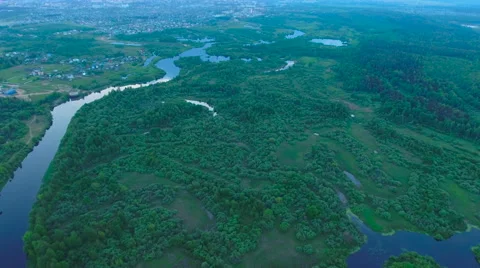 Aerial View. Flying over the river green trees at sunset with sun. Stock Footage 64961856