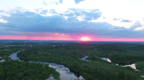Aerial View. Flying over the river green trees at sunset with sun. Stock Footage 64963065